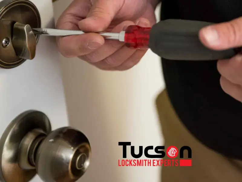 man installing deadbolt lock in front door