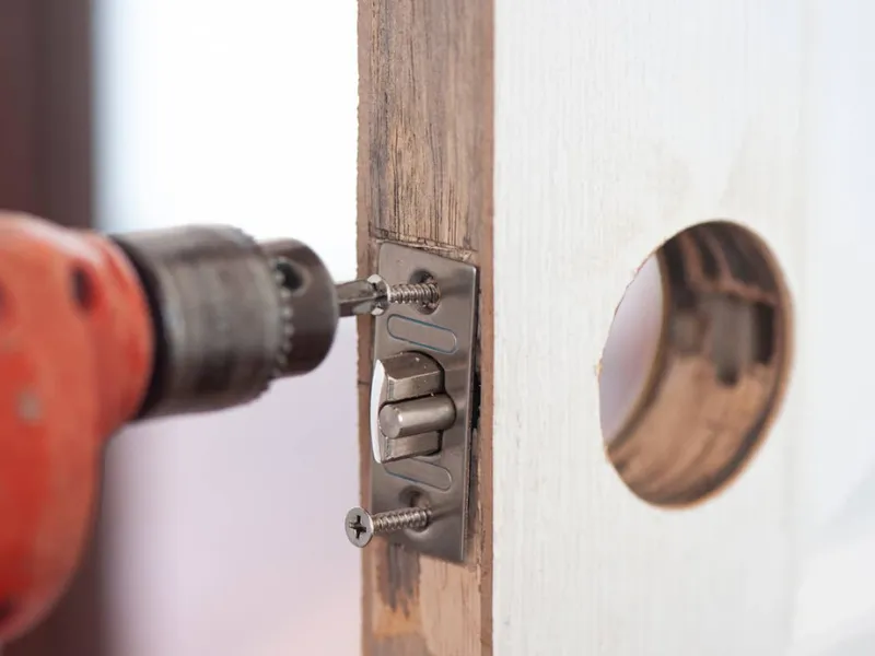 drilling screws in place for lock installation